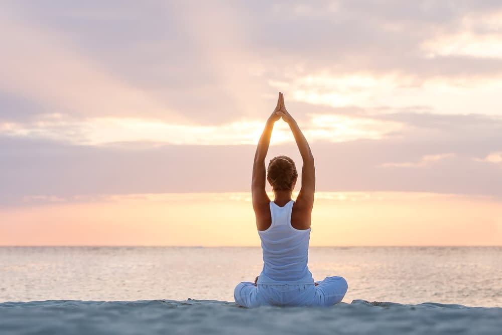 Caucasian,Woman,Practicing,Yoga,At,Seashore